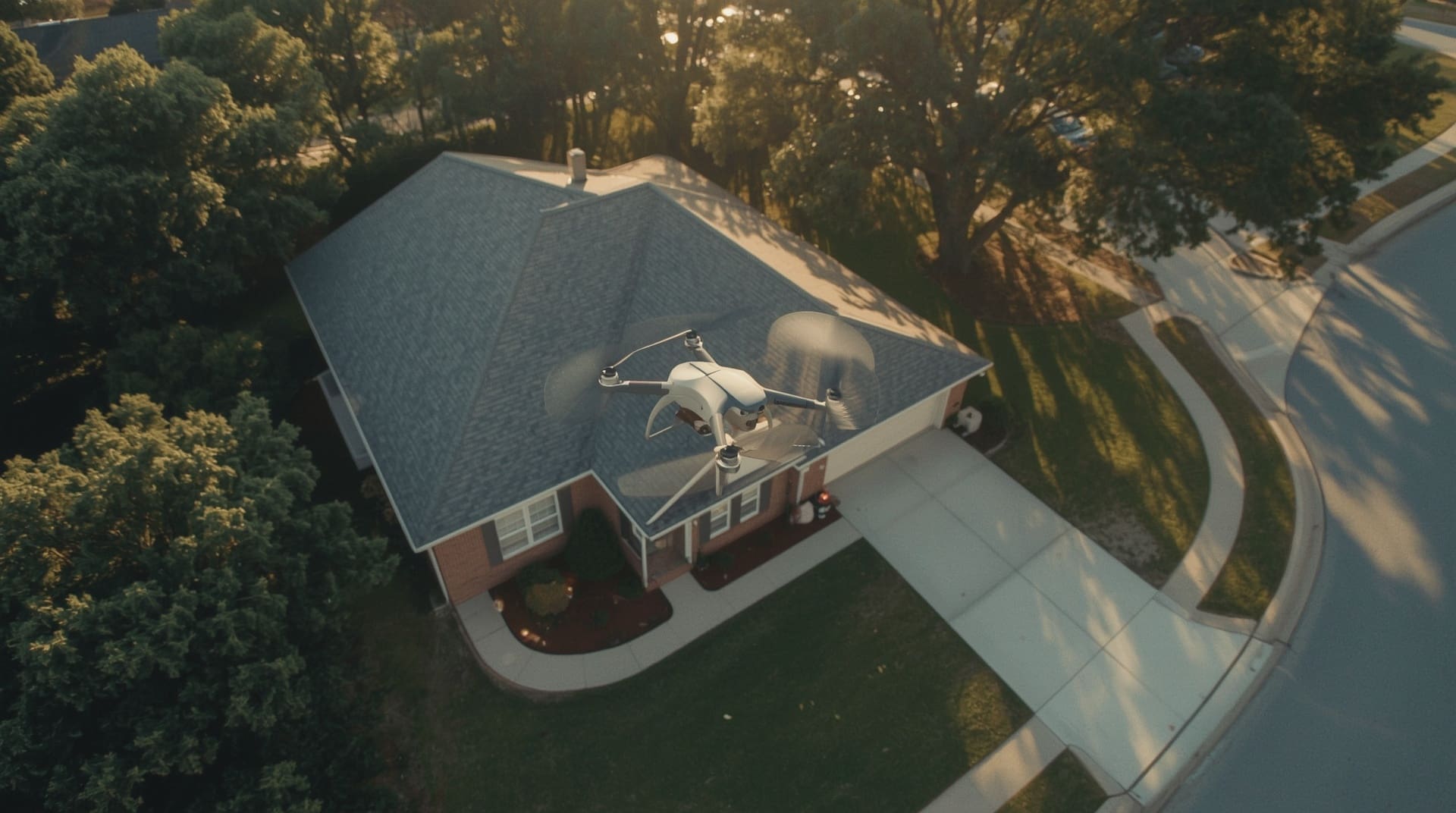 Professional drone hovering above suburban two-story home during golden hour aerial real estate photography